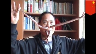 Man pulls live snakes through his nose and mouth