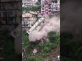 Multi-story building collapses onto other homes