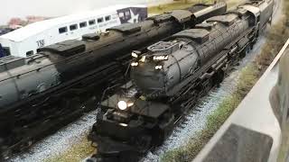 Two massive Big Boys #4014 and #4018 ride pass GM assembly plant at the TWMRC Two massive Big Boys #4014 and #4018 ride pass GM assembly plant at the TWMRC