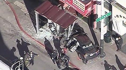 Car slams into bus stop, injuring 10