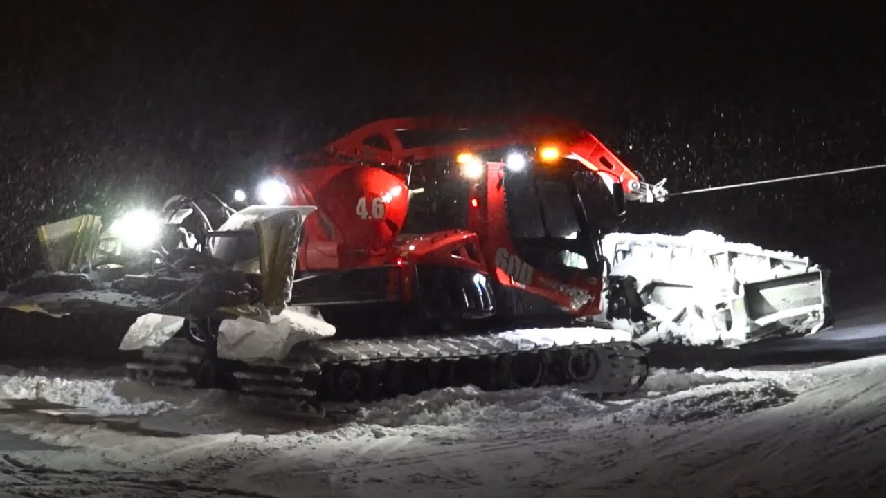 Pistenbully 600W Polar Level Red Grooming under a Heavy Snowfall