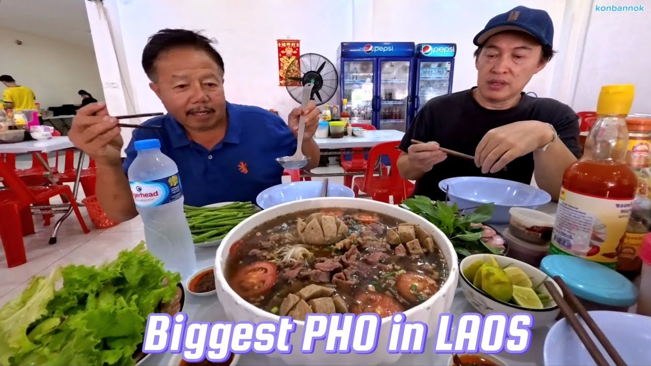 4 people eating 1 biggest bowl of Pho in Laos