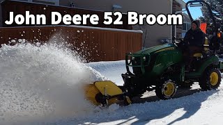 John Deere 1025R and 52 Broom doing snow removal