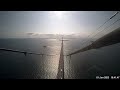 US Navy ship passes under the Great Belt Bridge