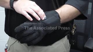 Kentucky jailer demonstrates shock gloves being considered for federal immigration officers