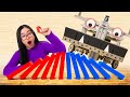 HUMAN vs. ROBOT Domino Building Machine! (w/ Mark Rober)