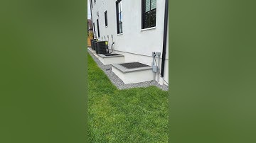 Concrete window wells - stucco house