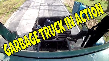 On The Go Adventure watches a fully automated garbage truck, dumping cans and packing garbage.