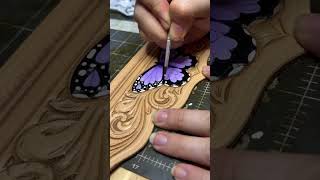 Painting a butterfly on tooled leather!