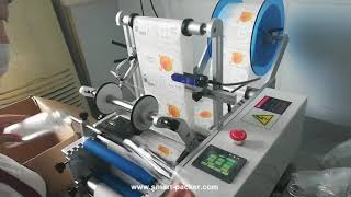Semi automatic tabletop juice empty plastic bottle labeling machine round bottle rolling labeling