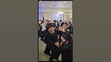 Thumbnail of Two Hasidic men dancing by a Jewish wedding