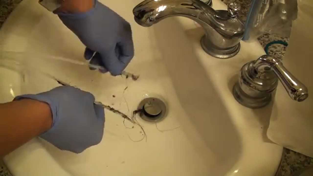 Cleaning A Hair Clog From A Sink Using A Zip It Like Homemade Device