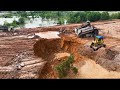 Strong Powerful Bulldozers Pushing Rock&amp;Soil Filling Sink Land With a Hundred Dump Trucks