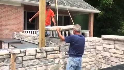 Crane setting limestone coping