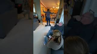 Woman rides hoverboard in living room and falls on kid
