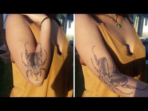 Ladybug tattoo fully reveals only after you extend your arm