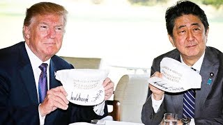 Trump Forces Japanese Prime Minister To Hold His Stupid Hats