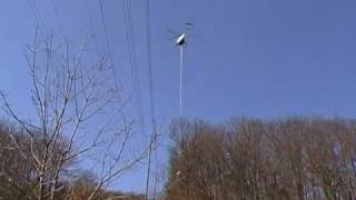 Helicopter Trimming Trees around Power Lines Very Close to Power Lines