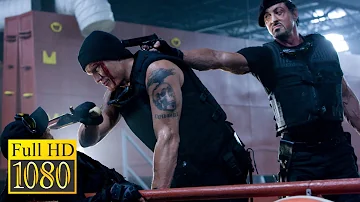 Sylvester Stallone and Jet Li punish Dolph Lundgren in the movie The Expendables (2010)