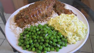 Smothered Turkey Wings with brown gravy over rice green peas and potato salad