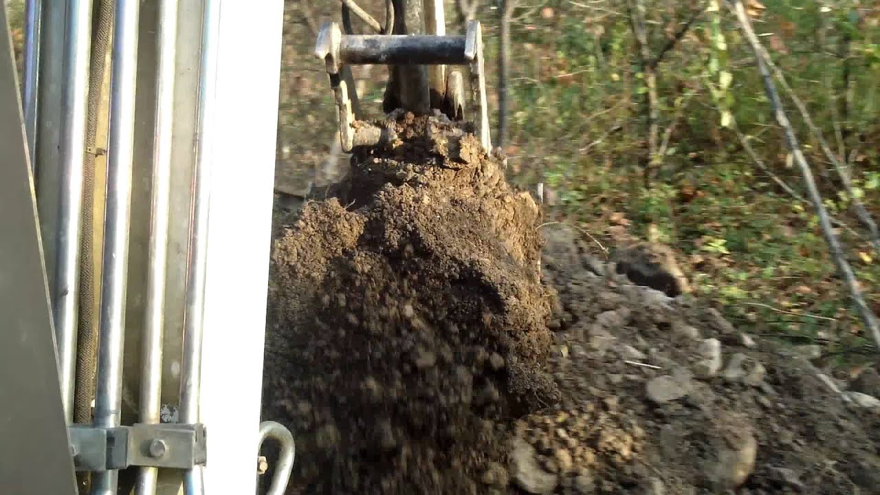 bobcat 334 digging hole to bury brush YouTube