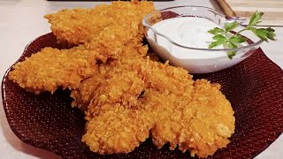 Crispy chicken breast fillet with cornflakes and garlic sauce