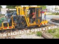 The nordco railroad tie spiker at work on 90 year old track with a tie extractor