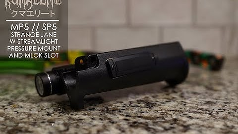 Kuma Elite’s HK MP5 and SP5 Strange Jane hand-guard w/ VFG + streamlight pressure switch mount.