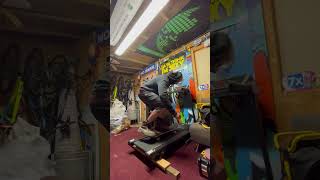 Guy riding skateboard on treadmill attempts pop shuvit then falls forward and bumps head on handle