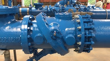 Tilted disc check valve closure with surge tank