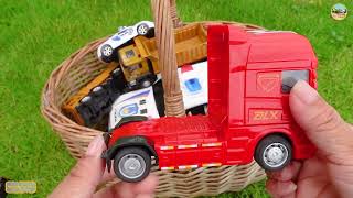 Interesting basket containing all kinds of toy cars, fire trucks,dump trucks, police cars,bulldozers