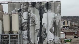 Mankato MN Arden Mills Roof Project in front of a  beautiful  Mural work of Art.