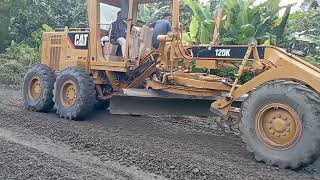Caterpillar 120K motor grader, just a few steps until the road is finished