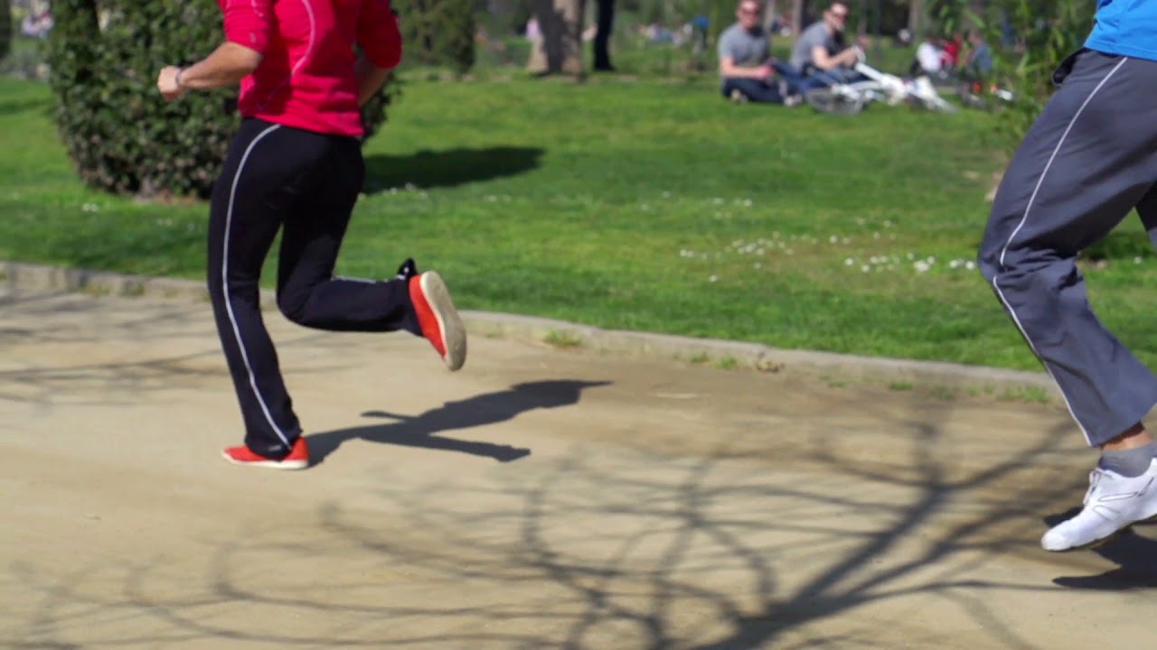 people jogging in park slow motion shot a s steadycam shot