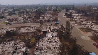 Drone video shows the town keswick and a nearby neighborhood that were
destroyed by carr fire in late july; young family gazes over what used
to be...
