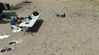 Slow-motion action of a .50 BMG muzzle blast blowing everything off our shooting table