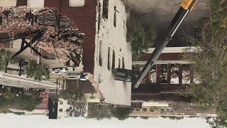 Crews knock down abandoned funeral home after weekend fire