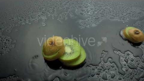 Sliced Kiwi Fruit Fall On Wet Pack - Stock Footage | VideoHive 10282845