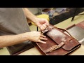 Leather craftsman making a satchel