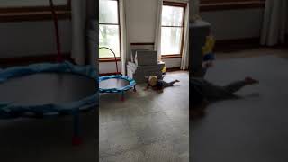 Boy jumps off padded platform the trips over triangular padding and faceplants