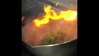 Chef cooking with flame in frying pan on a kitchen stove! #shorts