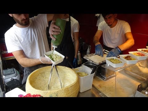 italian-street-food:-hand-rolled-pasta-fettuccine-alfredo-by-cheese-wheel,-camden-lock-market-london