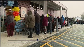 Local residents stand out in the cold as new ALDI store opens
