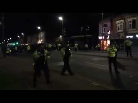 Massively outnumbered but brave police face glass bottle missiles while trying to maintain peace.