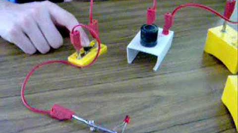 To show that a capacitor blocks d.c. but conducts a.c.