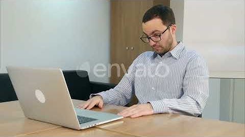 Concentrated Bearded Young Man Using Laptop for Studying | Stock Footage - Envato elements
