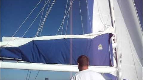 Transit 38 catamaran dropping the mainsail into lazy jacks.wmv