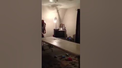 Guy fails at slide down beer pong table