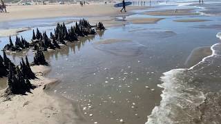 Sandcastle destroyed by a wave