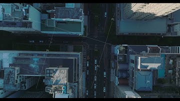 Aerial birds eye overhead top down view of wide street and road intersection between high rise